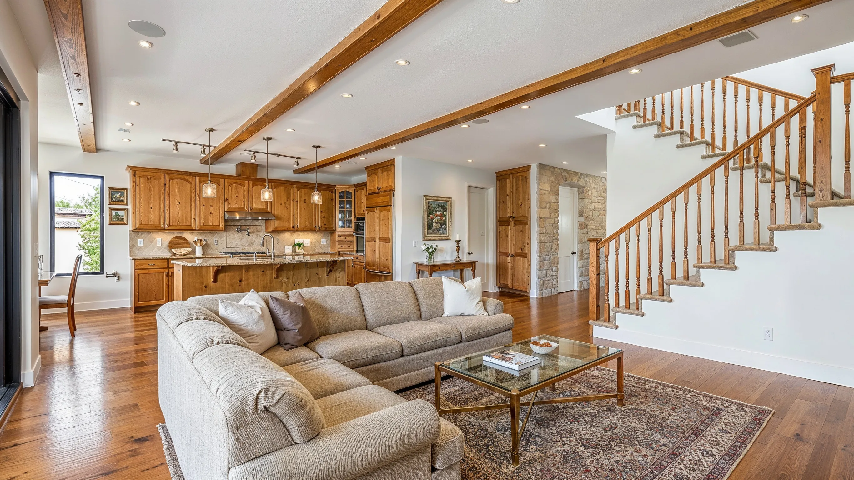 Before home remodeling project in Los Angeles with outdated living room, older kitchen layout, dated finishes, and closed interior flow