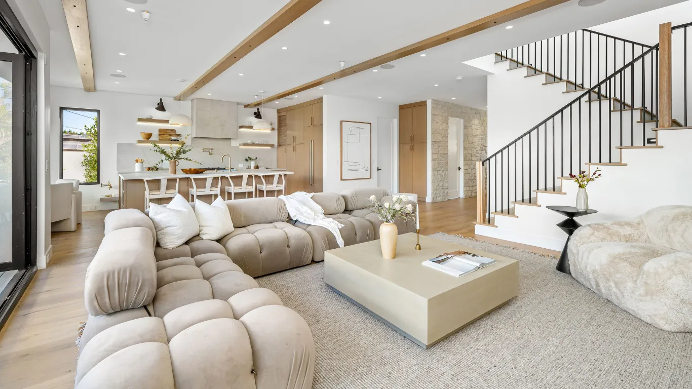 Home remodeling project in Los Angeles with open-concept living room, modern kitchen, staircase update, wood flooring, recessed lighting, and bright interior layout