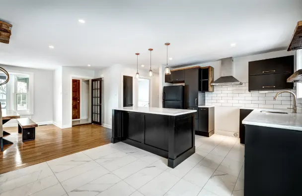 Condo remodeling in Los Angeles with modern staircase renovation, light wood steps, metal railing, white walls, and updated interior flooring