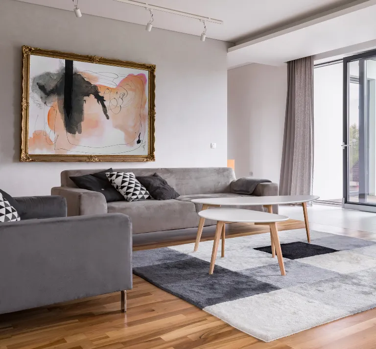 Home remodeling in Los Angeles with luxury living room remodel, modern furniture, custom wall art, natural light, and upgraded flooring