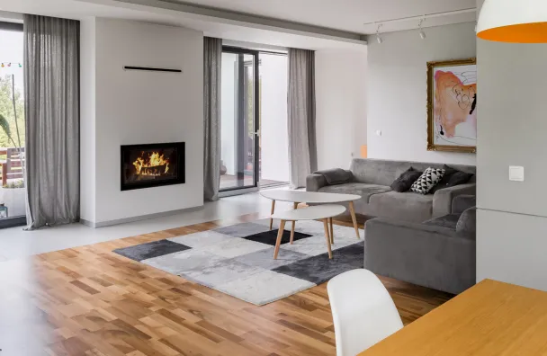 Home remodeling in Los Angeles with open living room upgrade, fireplace feature wall, hardwood floors, large windows, and modern interior layout