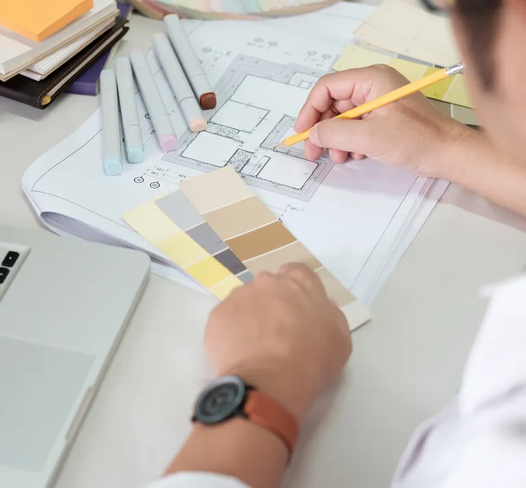 Remodeling permits and planning in Los Angeles with contractor reviewing floor plans, color samples, layout details, and renovation project documents